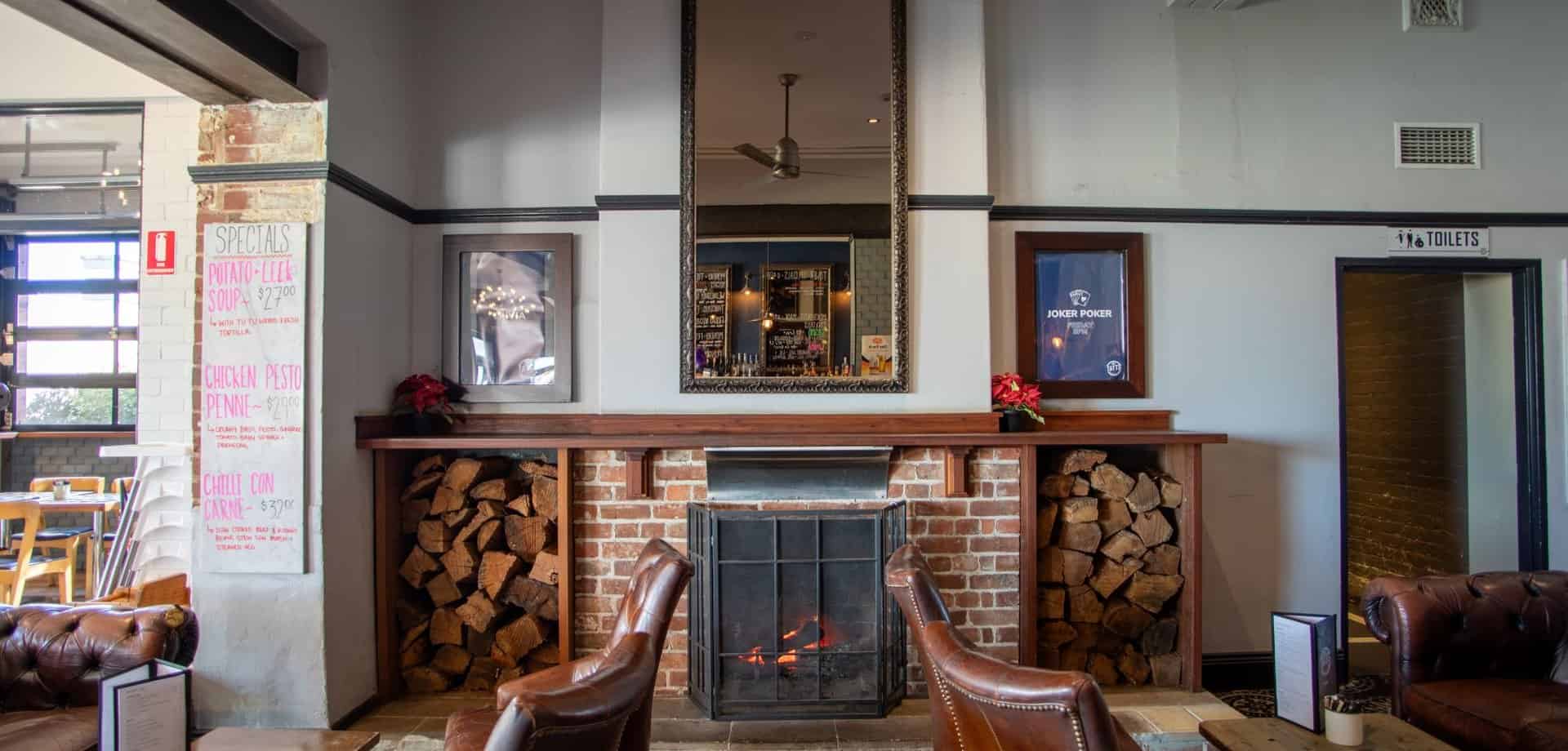 Lounge seating beside the open fireplace at The Tatts