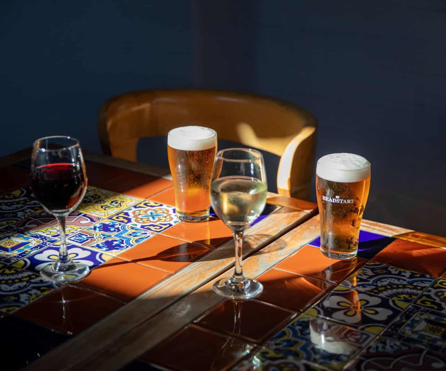 Wine and beer served on a tiled table